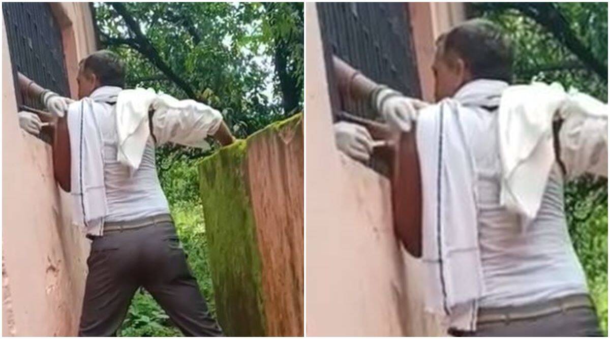 Watch: As people wait in queue outside building, man gets vaccinated through the window | Trending News,The Indian Express